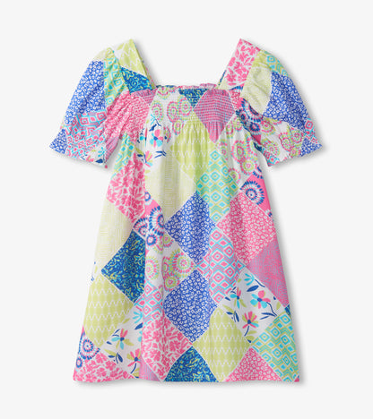 Girls patchwork smocked dress with square neckline, puff sleeves, and pink, blue, and green print