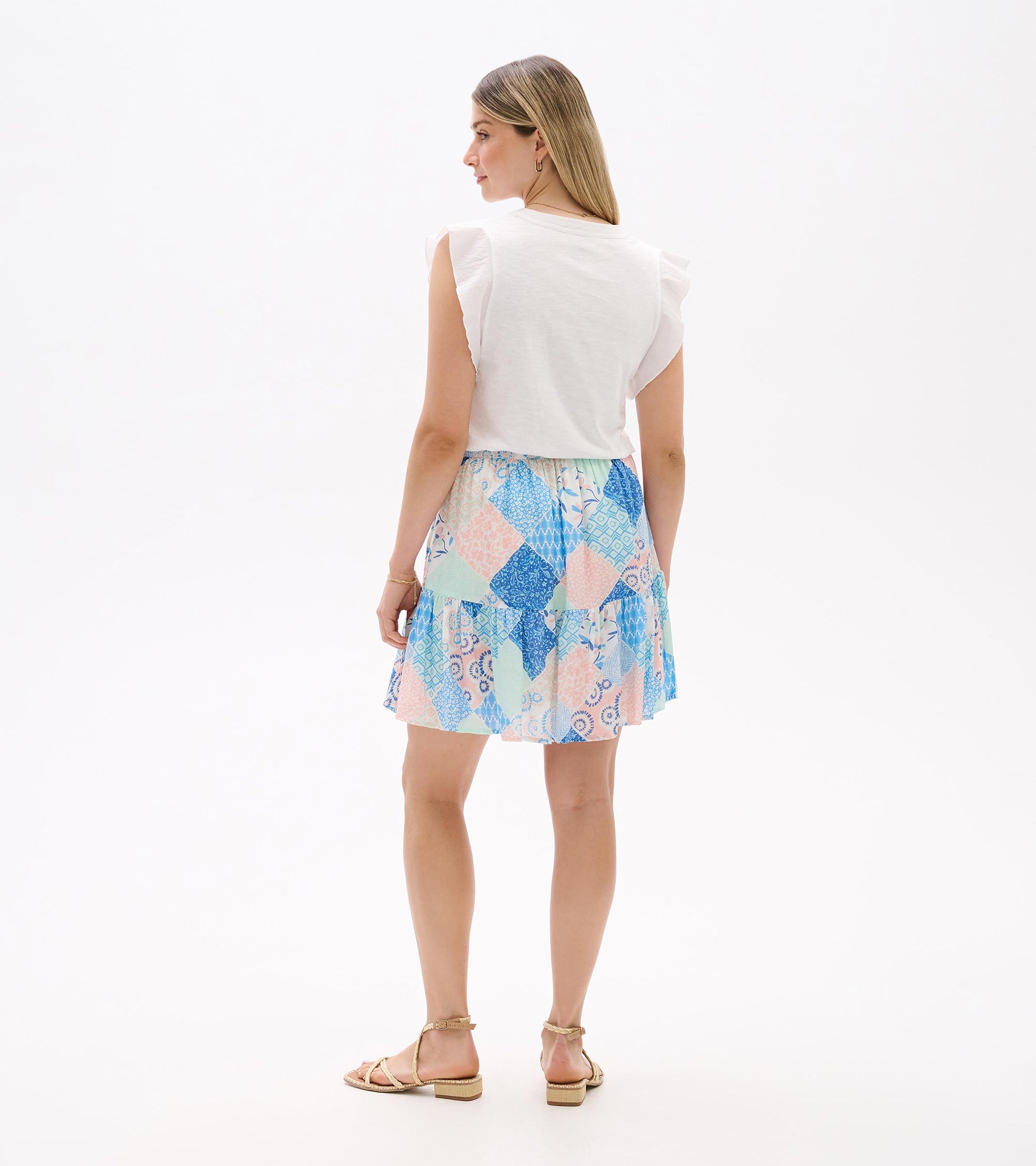 Back view of a pastel blue, pink, and mint patchwork flounce skirt with layered ruffle hem.