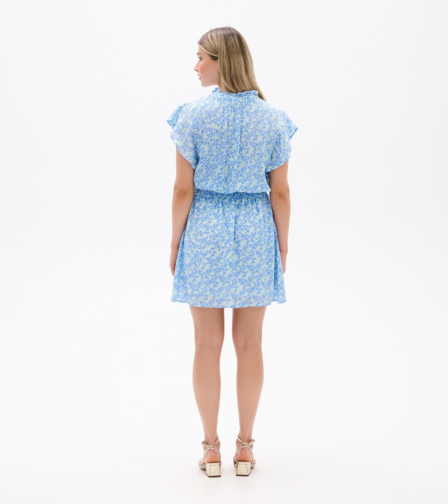 Back view of Ava Dress in blue and soft green mini vine print with flutter sleeves and smocked waist