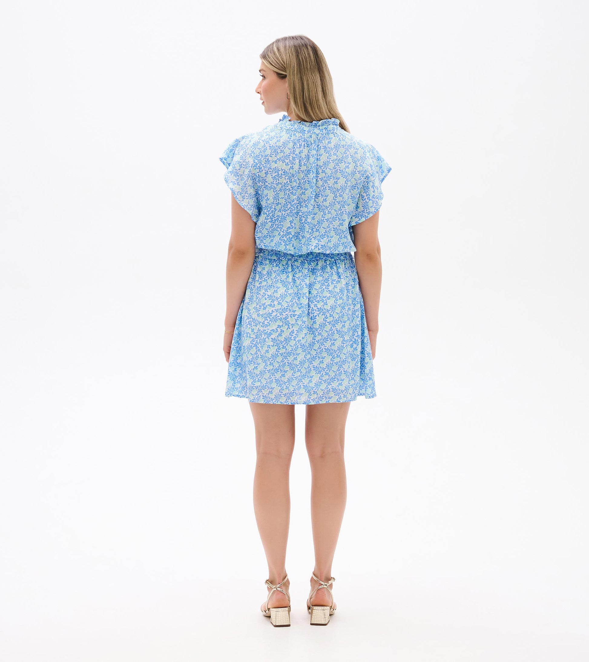 Back view of Ava Dress in blue and soft green mini vine print with flutter sleeves and smocked waist