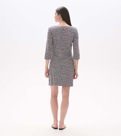 Back view of a navy mini dress with pink floral vine print, notch neck, and three-quarter sleeves