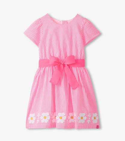 Pink and white striped girls dress with short sleeves, scoop neck, pink waist bow, and floral hem trim