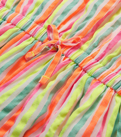 Close-up of the dress waist tie and gathered seam with neon pink, orange, yellow and mint stripes