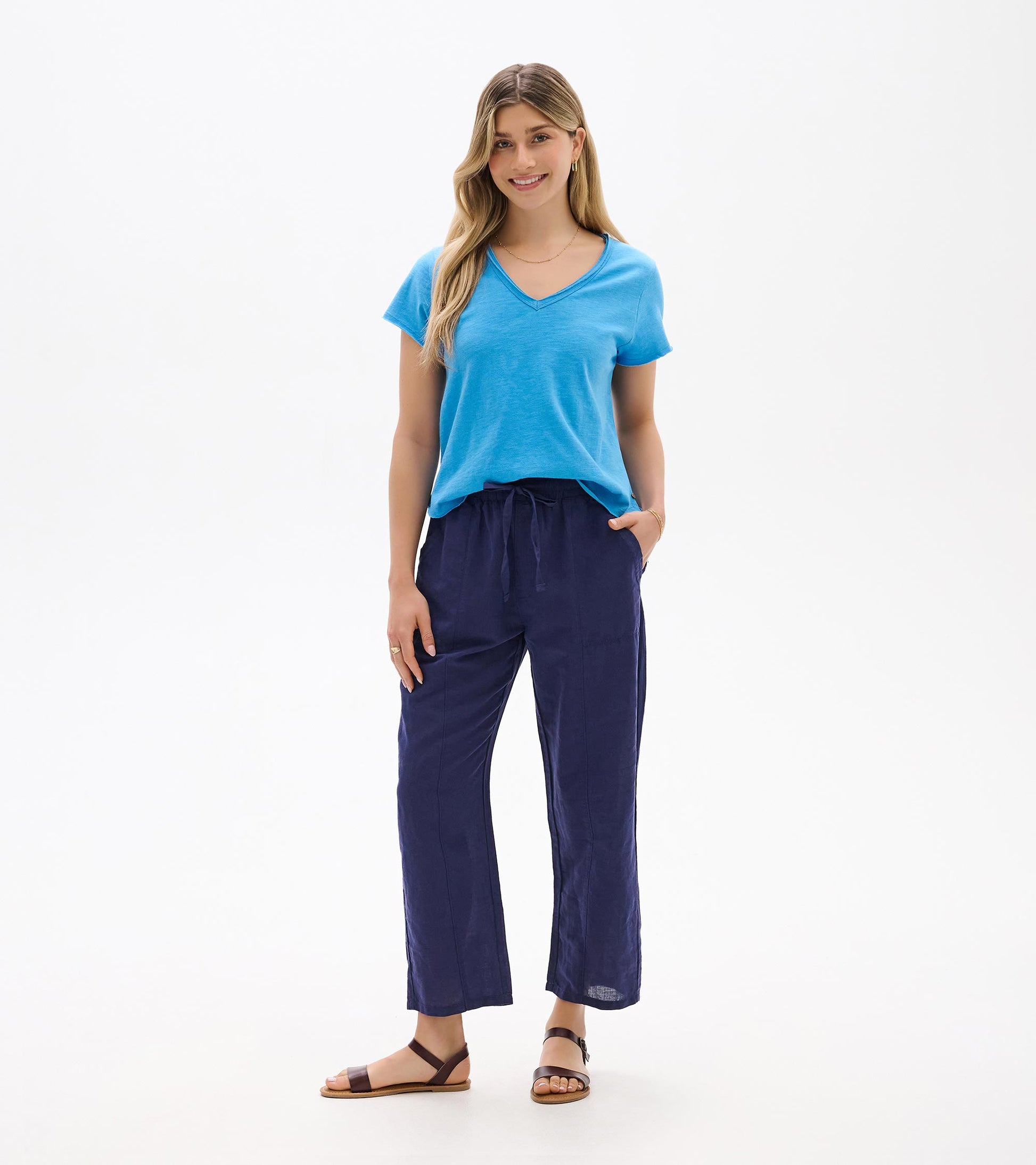 Front view of navy straight-leg pants with elastic waist and drawstring, worn with a blue T-shirt.