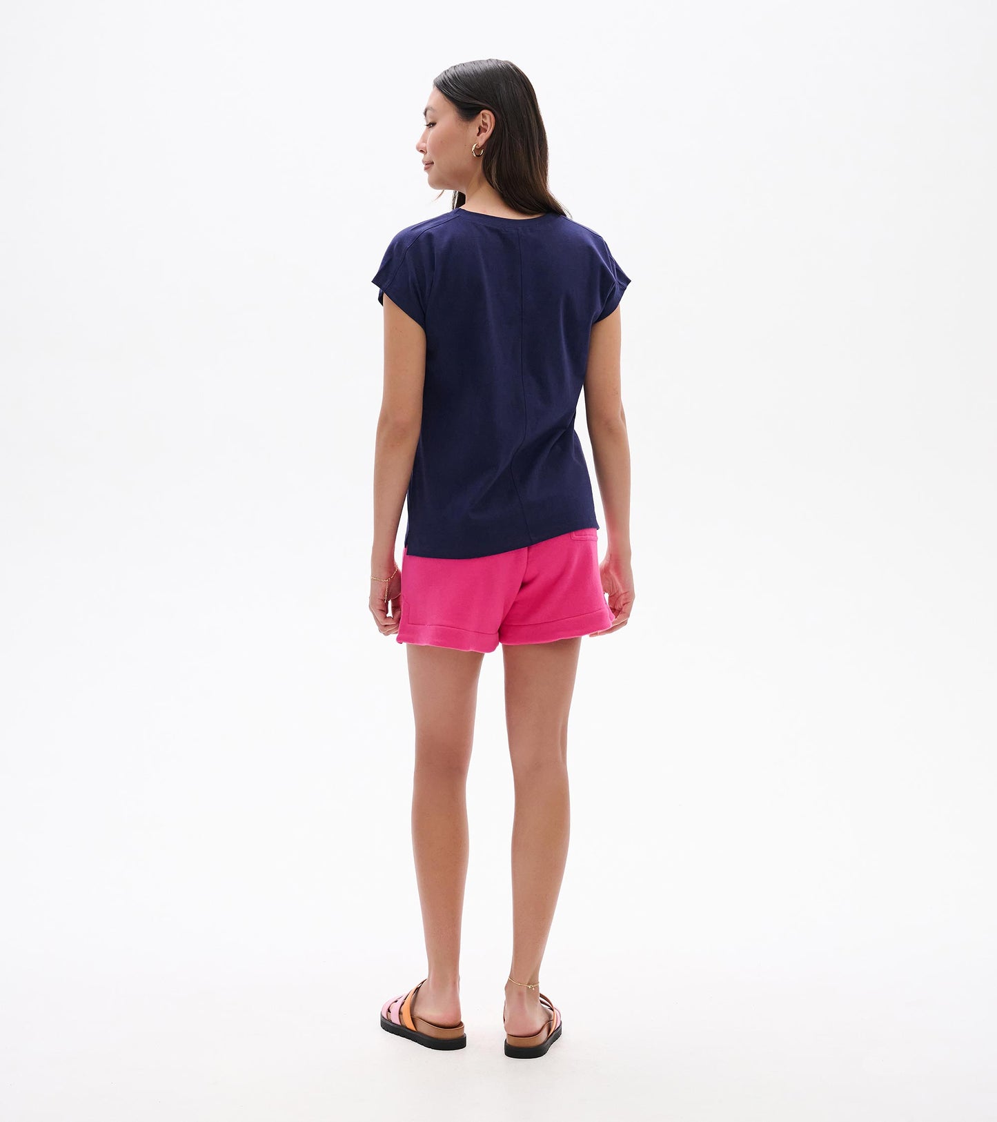 Back view of a relaxed navy short-sleeve tee with a loose fit and curved hem
