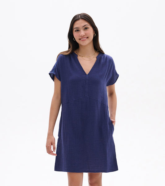 Woman wearing a navy blue short-sleeve V-neck dress with a relaxed knee-length fit, front view