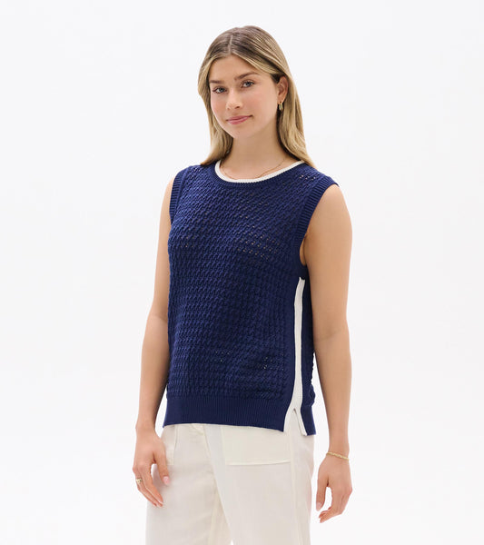 Navy blue sleeveless knit tank top with white trim and side slit, front view on model