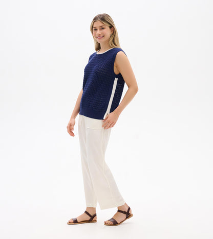 Navy blue sleeveless knit tank top with white side stripe, shown on model, front view