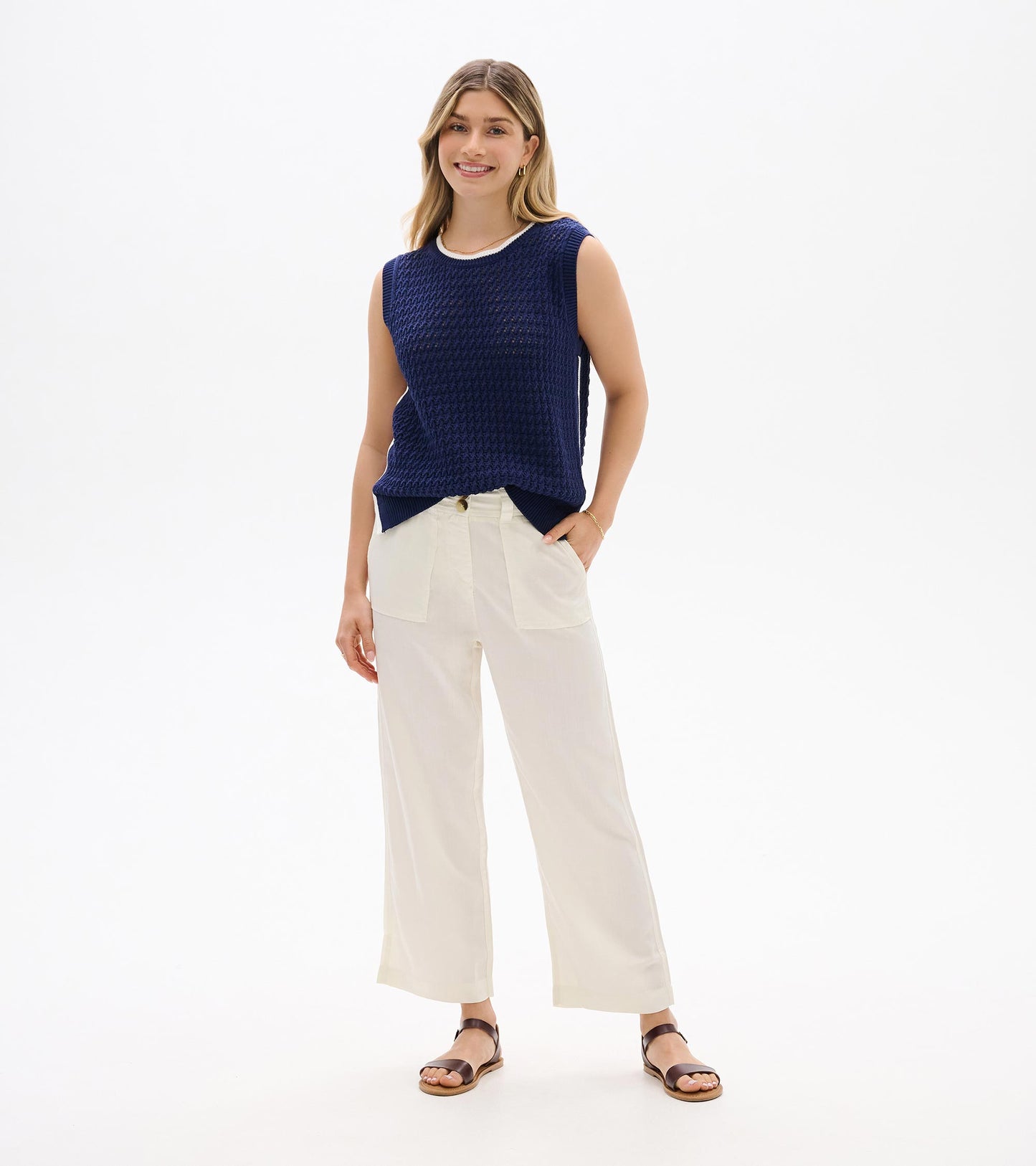 Navy blue sleeveless knit tank top with crew neck, shown on a model front view.