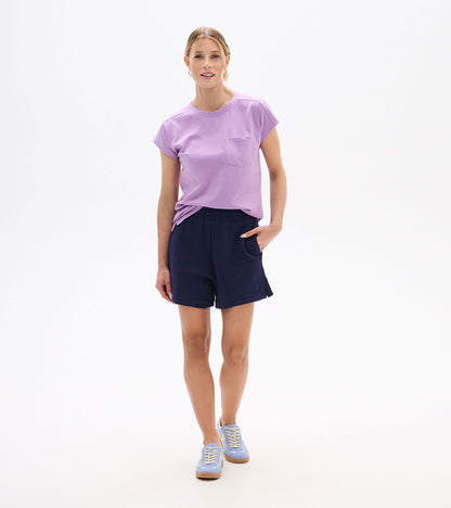 Woman wearing navy pull-on shorts with elastic waist and side pockets, front view