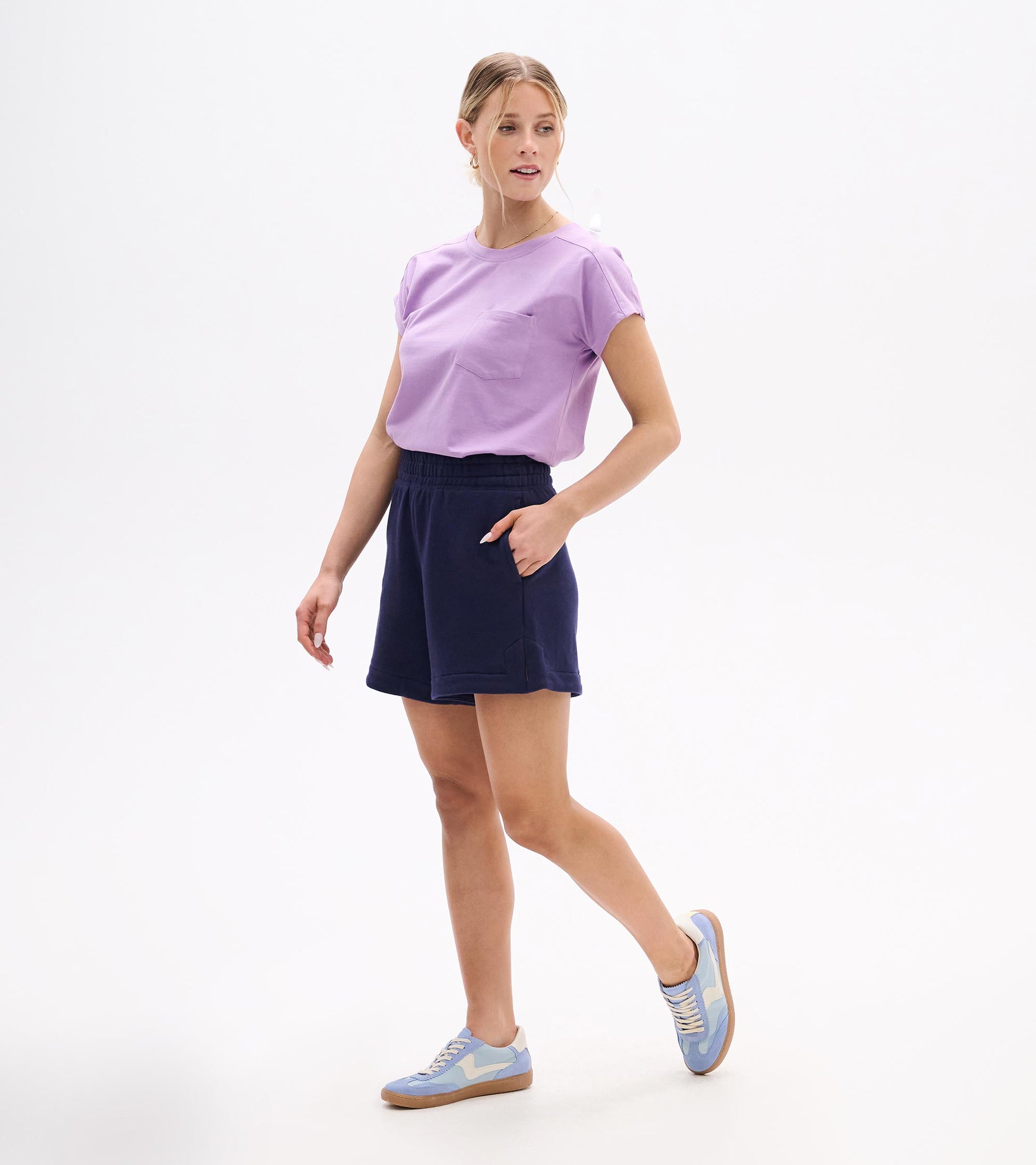 Woman wearing navy pull-on shorts with elastic waistband and side pockets, shown front view.