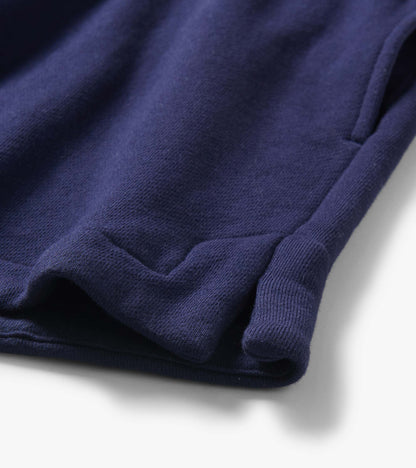 Close-up of navy blue knit shorts hem with folded cuff and visible seam detail