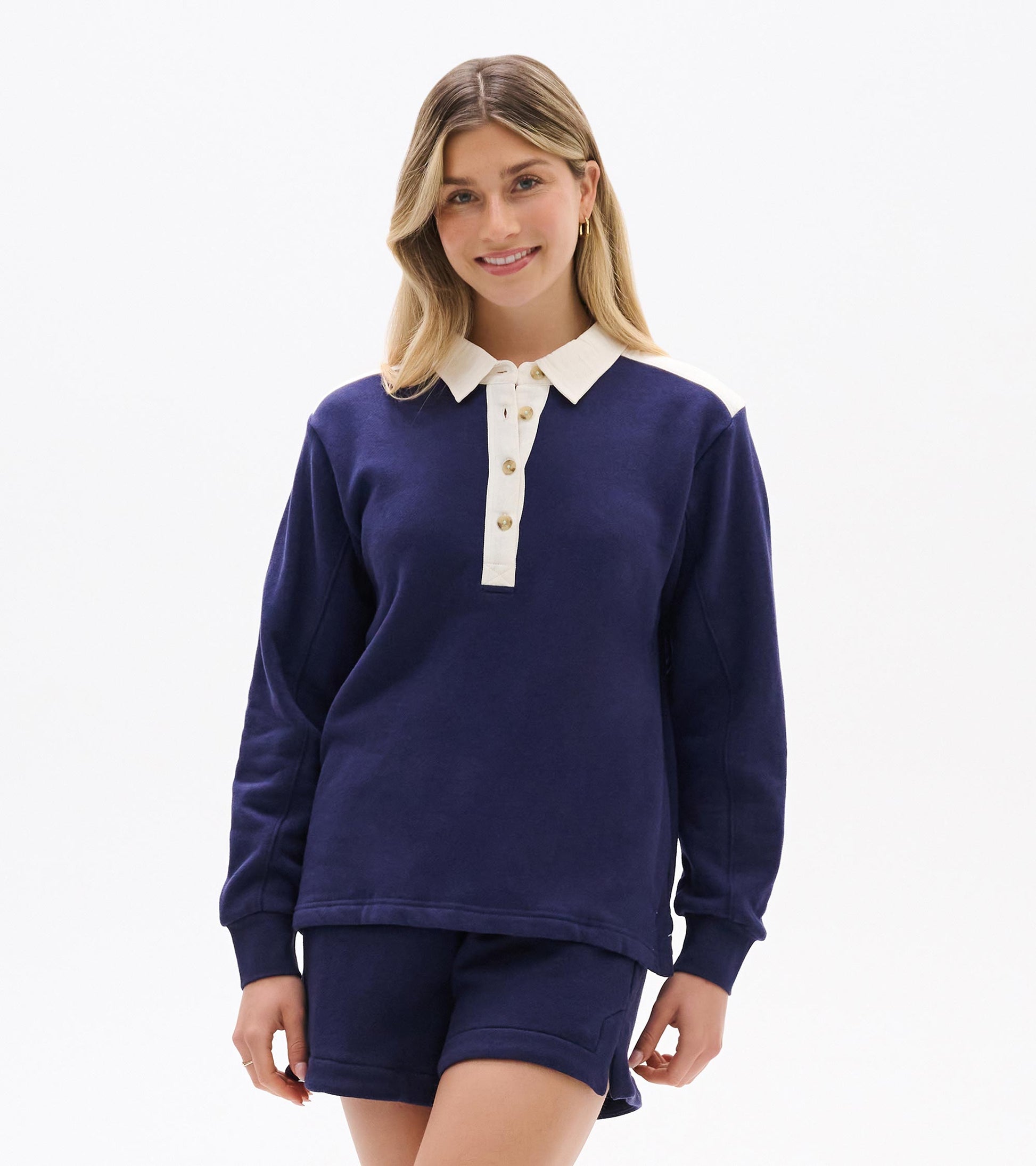 Patriot blue long-sleeve top with white collar, button placket, and shoulder accents, front view on model
