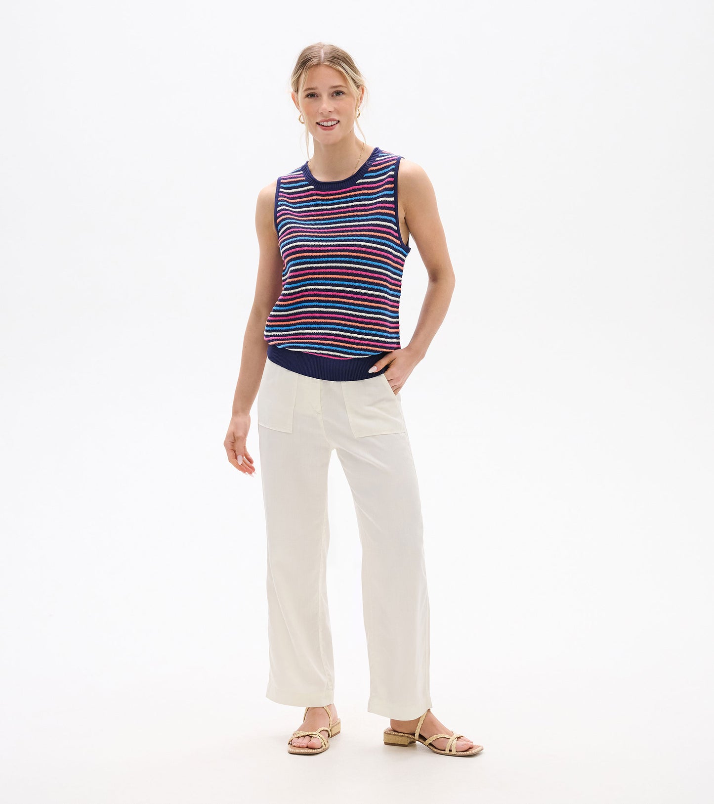 Sleeveless knit tank with navy, pink, blue, and white horizontal stripes, shown on a model front view.
