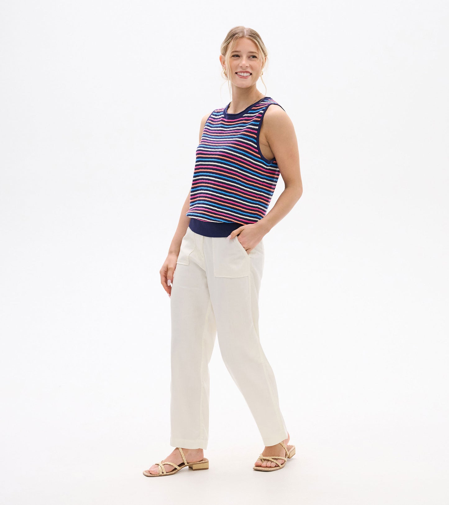 Sleeveless knit tank with multicolor horizontal stripes and navy trim, front view on model.