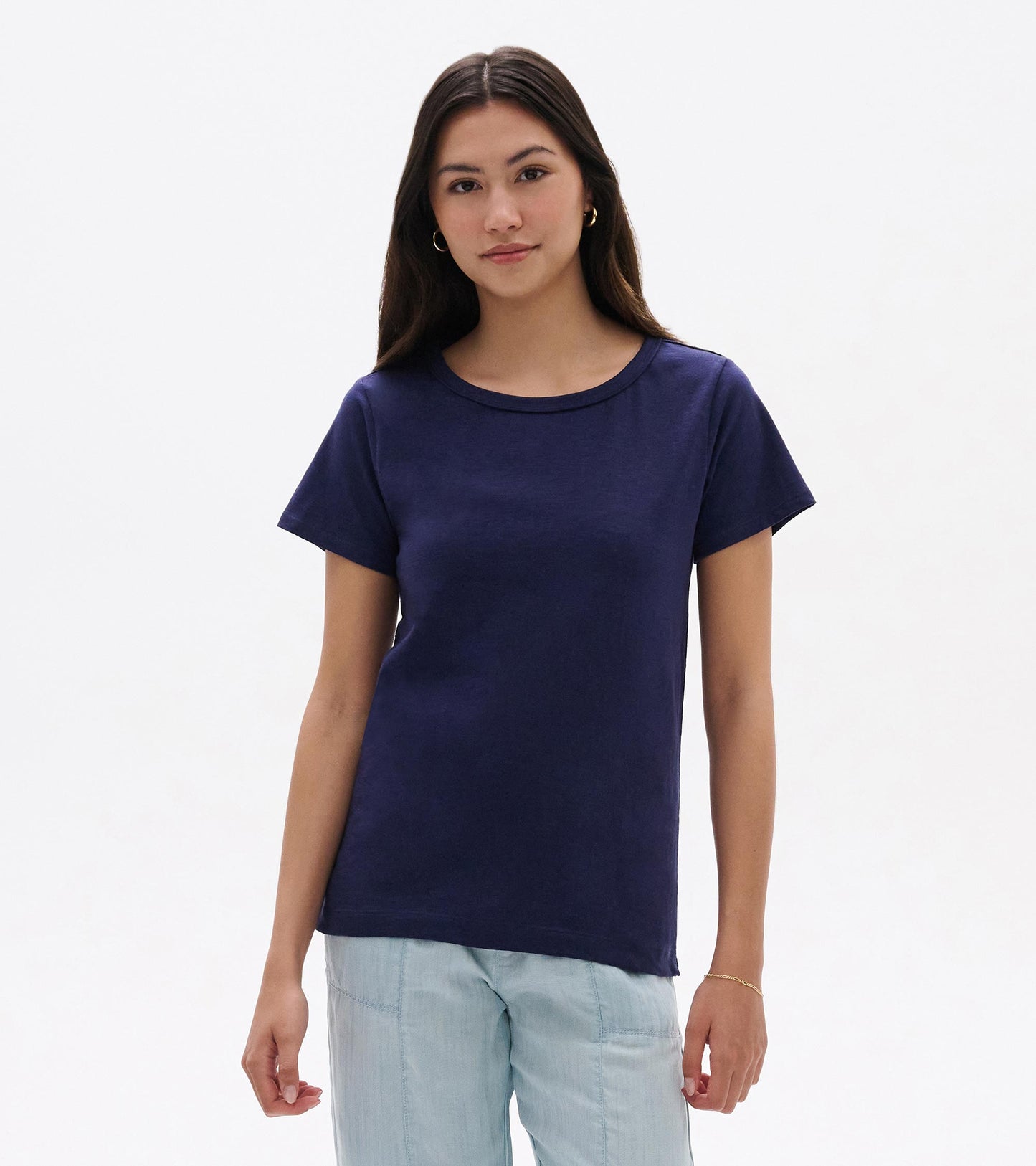 Navy blue crew neck short-sleeve tee, front view, worn with light blue pants.