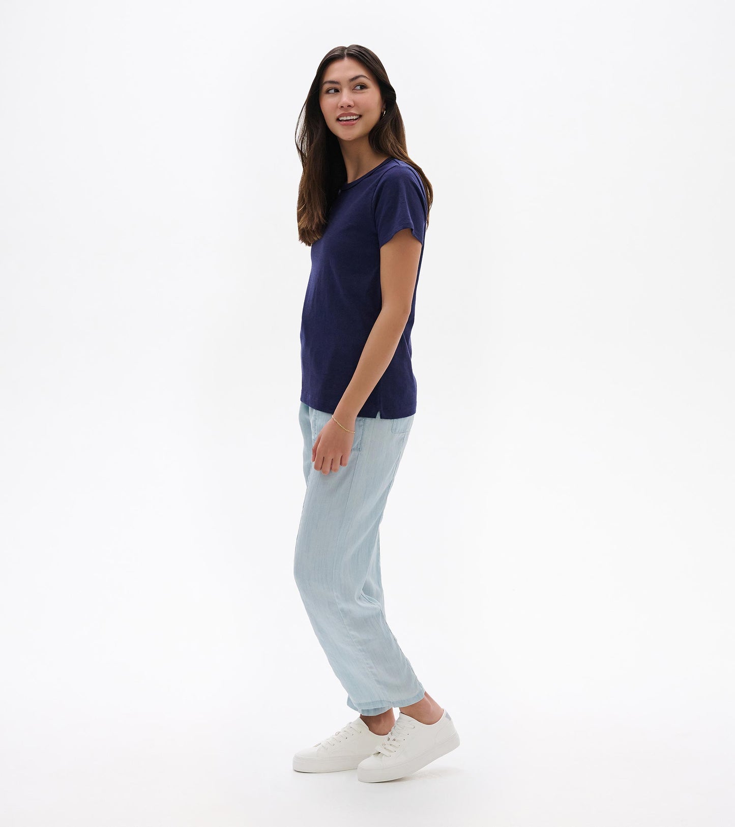 Navy blue short-sleeve crew neck tee with a relaxed fit, shown on a model in side view.