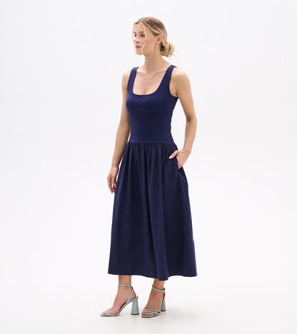 Sleeveless navy midi dress with scoop neckline, fitted bodice, and gathered skirt, front view