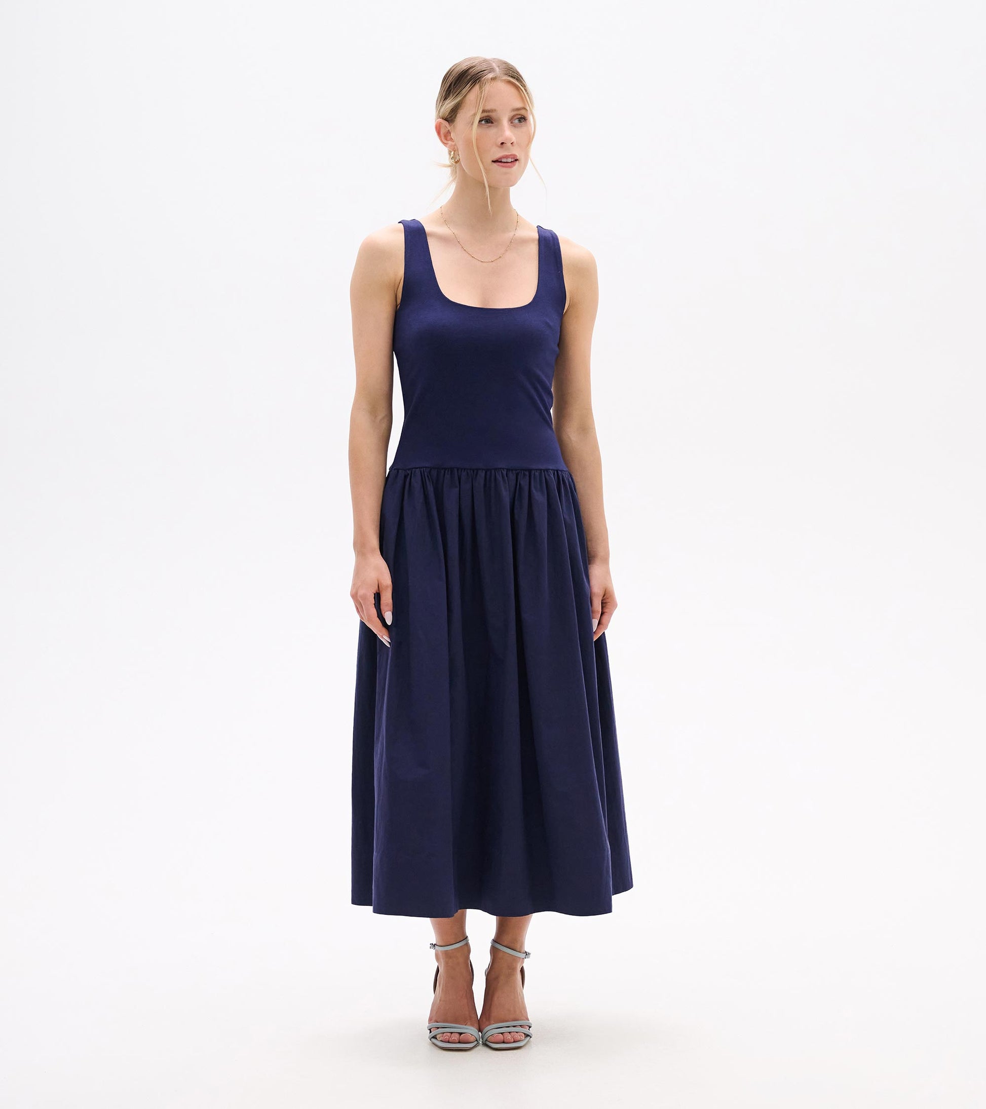 Front view of a navy sleeveless midi dress with scoop neckline and gathered skirt