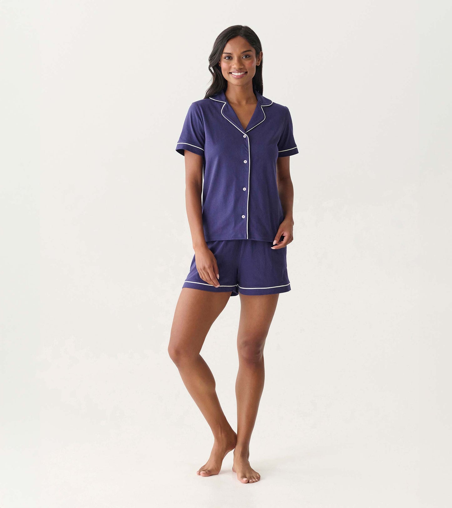 Front view of women's navy short pajama set with white piping