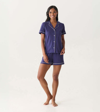Front view of women's navy short pajama set with white piping