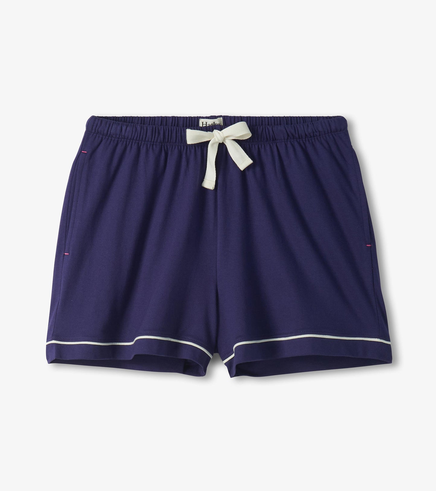 Navy pajama shorts with white piping, elastic waist, and white drawstring bow