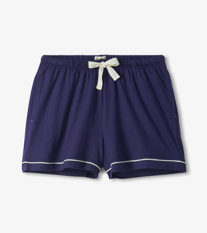 Navy pajama shorts with white piping, elastic waist, and white drawstring bow