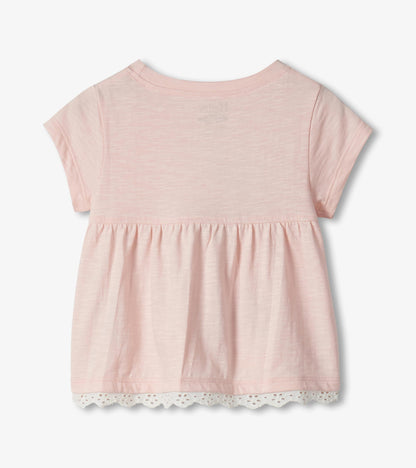Light pink short-sleeve toddler top with gathered hem and lace trim, back view