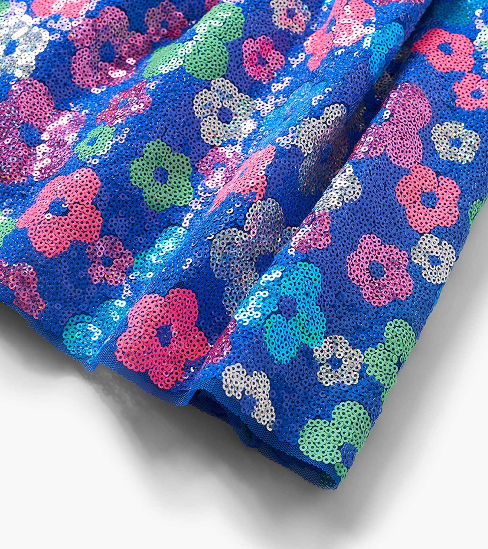Blue sequin skirt with multicolor floral pattern, folded close-up
