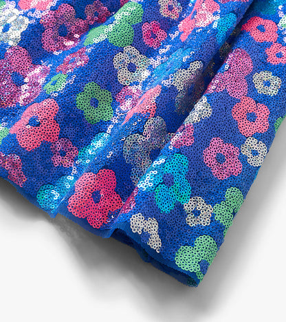 Blue sequin skirt with multicolor floral pattern, folded close-up