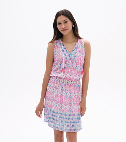 Front view of Chloe Dress in pink and blue print with sleeveless V-neck, tassel ties, and smocked waist