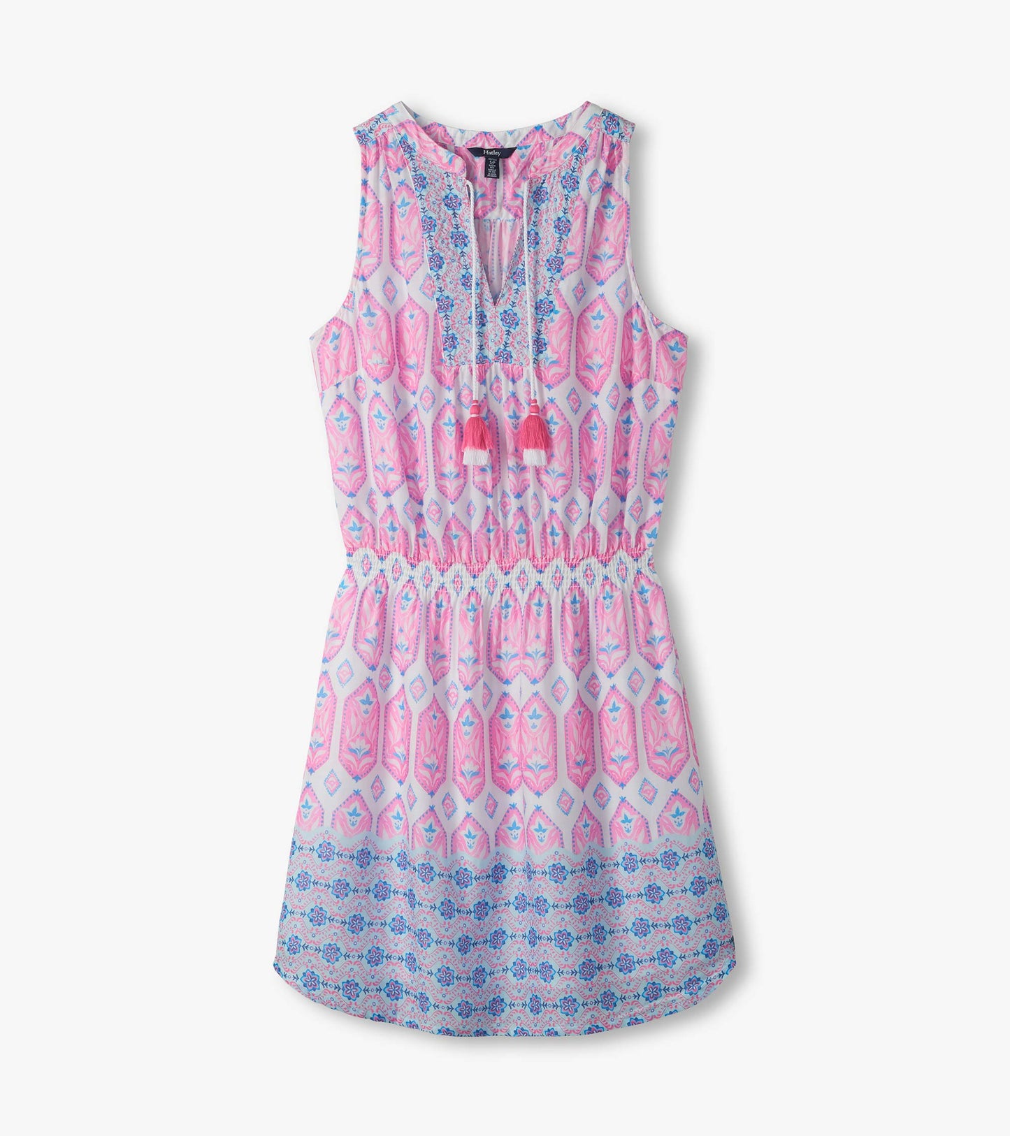 Close-up of Chloe Dress showing pink and blue print, split V-neckline, tassel ties, and smocked waist