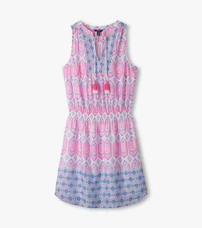 Close-up of Chloe Dress showing pink and blue print, split V-neckline, tassel ties, and smocked waist