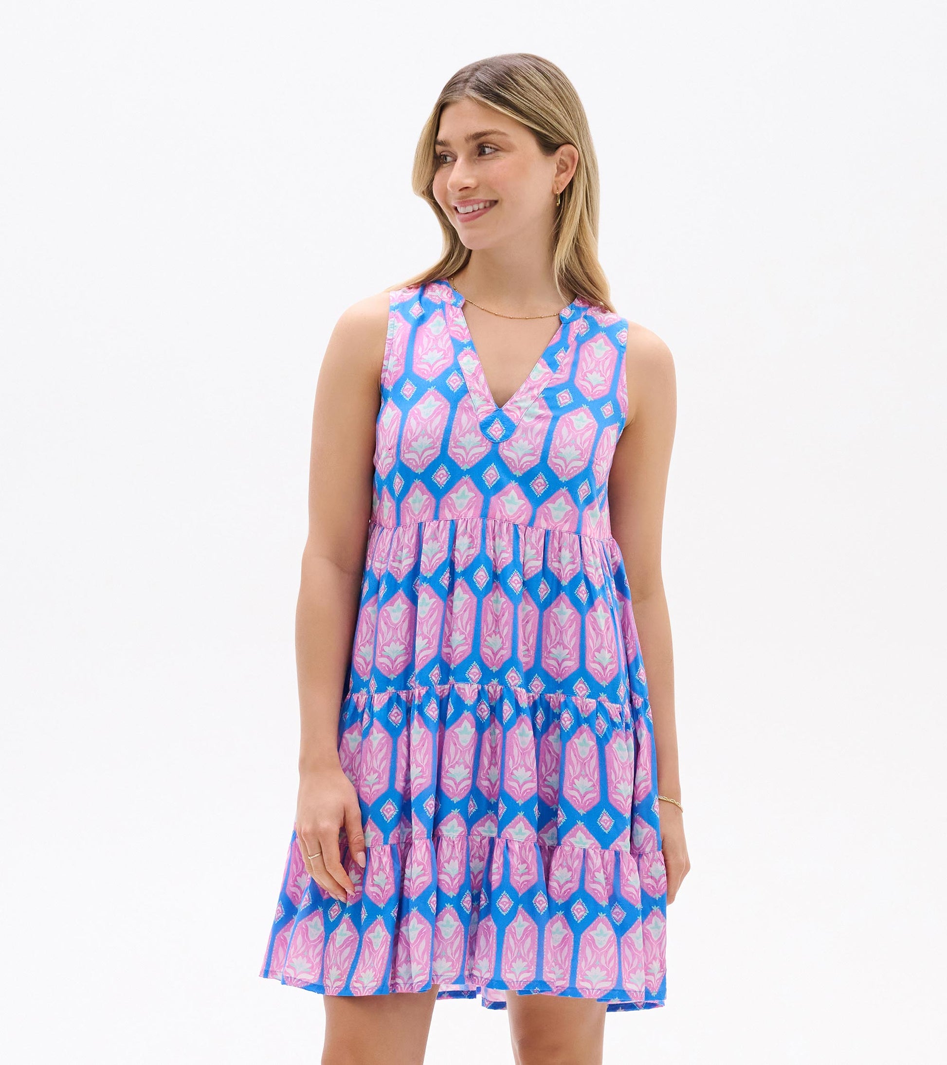 Sleeveless blue dress with pink floral print, V-neckline, empire waist and tiered skirt, front view