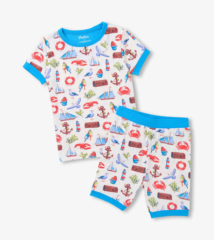 White short pajama set with blue trim and colorful seascape print, shown folded front view