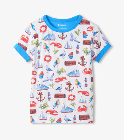 White boys pajama top with blue trim and colorful seascape print of boats, anchors, crabs, and lighthouses