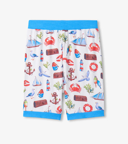 White boys’ pajama shorts with blue waistband and hem, featuring a colorful seascape print.