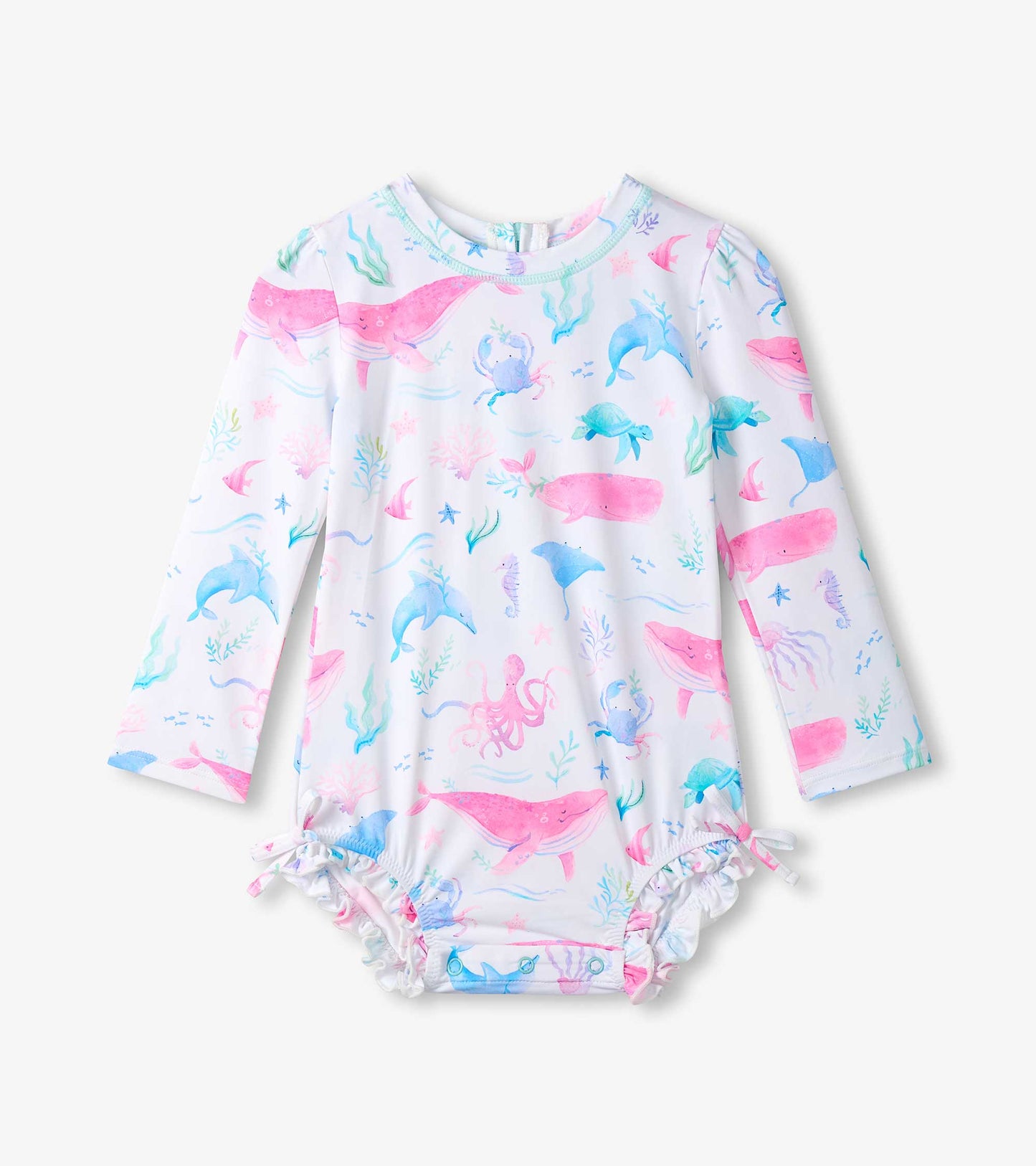 White long-sleeve baby rashguard swimsuit with pastel sea life print and ruffled leg openings, front view