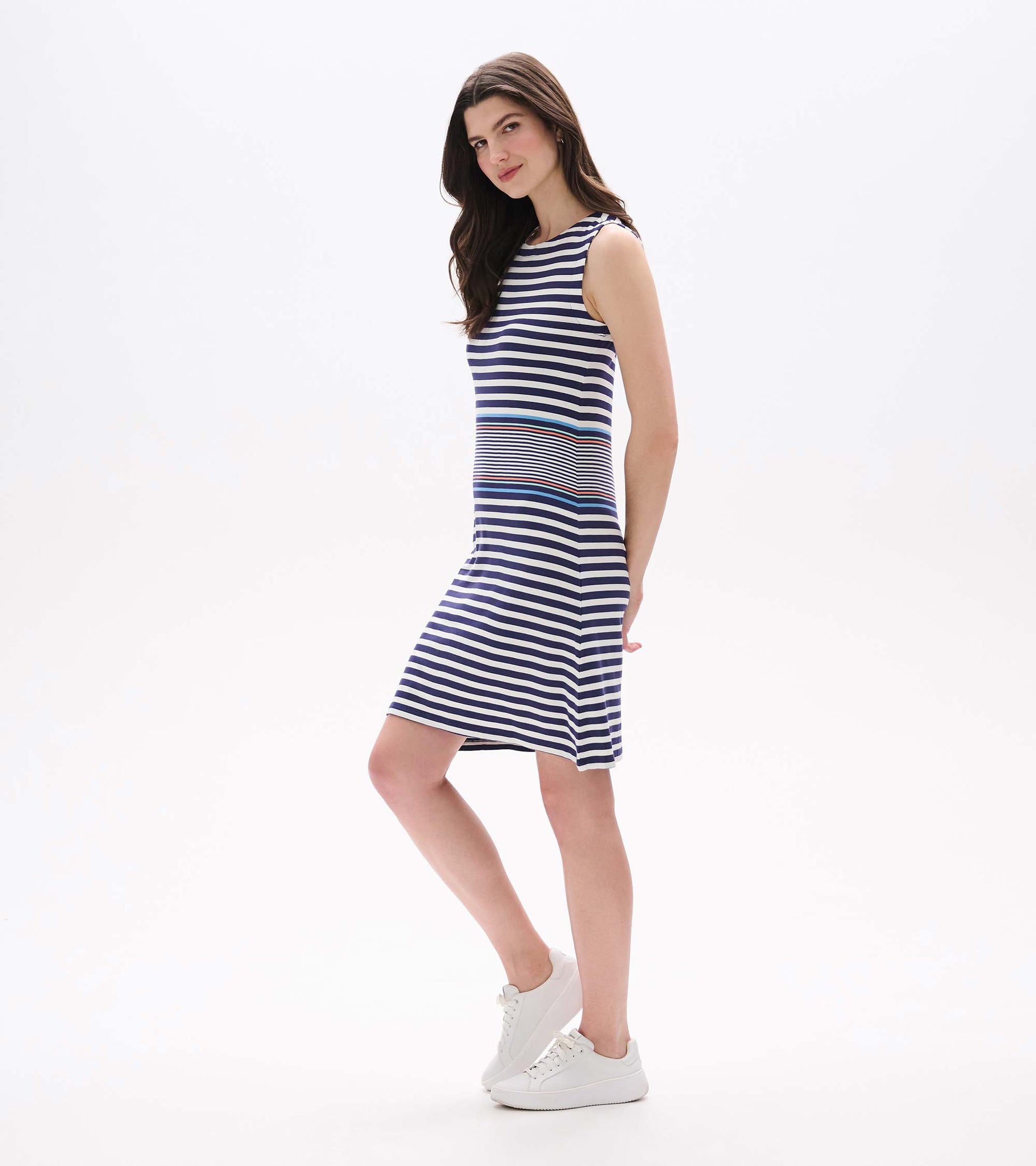 Side view of sleeveless A-line dress with navy and white stripes and blue and coral accent bands