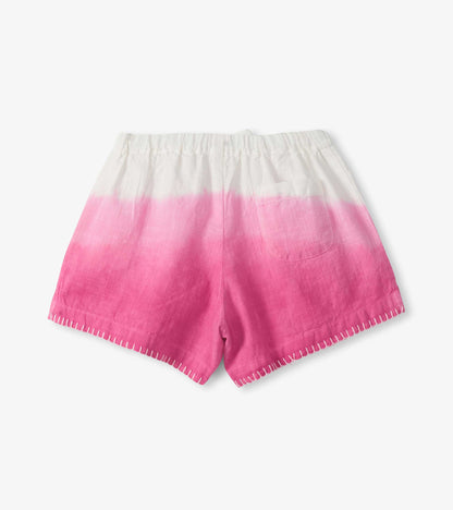 Girls woven shorts with white-to-pink dip dye, elastic waist, and stitched hem, front view
