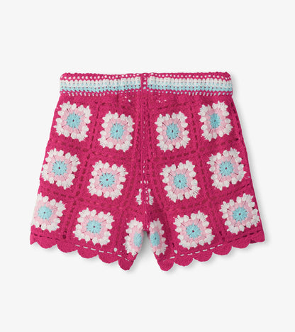 Pink crochet girls shorts with scalloped hem and pastel floral pattern, front view