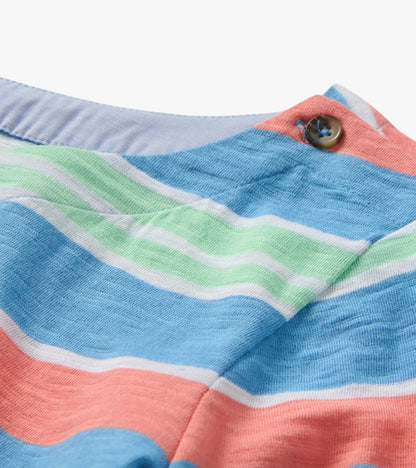 Close-up of a striped knit shirt in blue, coral, green, and white with a buttoned collar detail