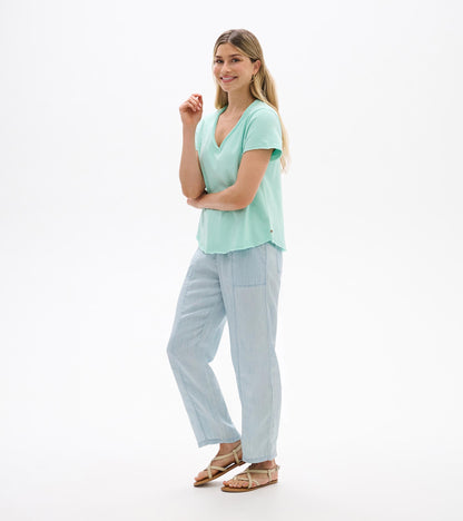 Woman wearing a sea glass green V-neck short-sleeve tee with a relaxed fit, front view.