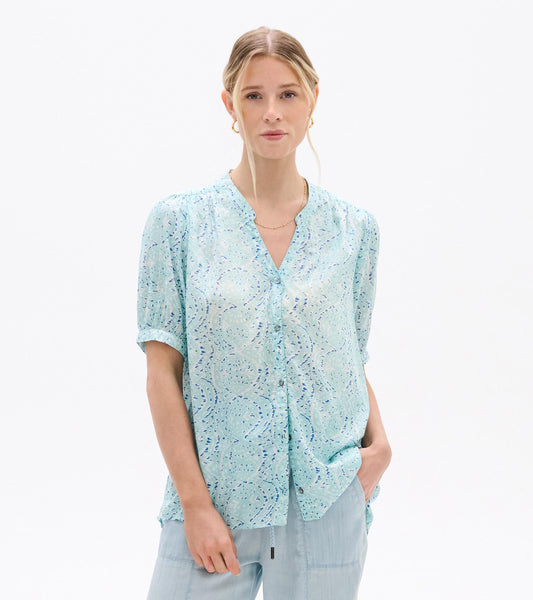 Light blue short-sleeve blouse with abstract ikat print, V-neck and button front, worn by model front view