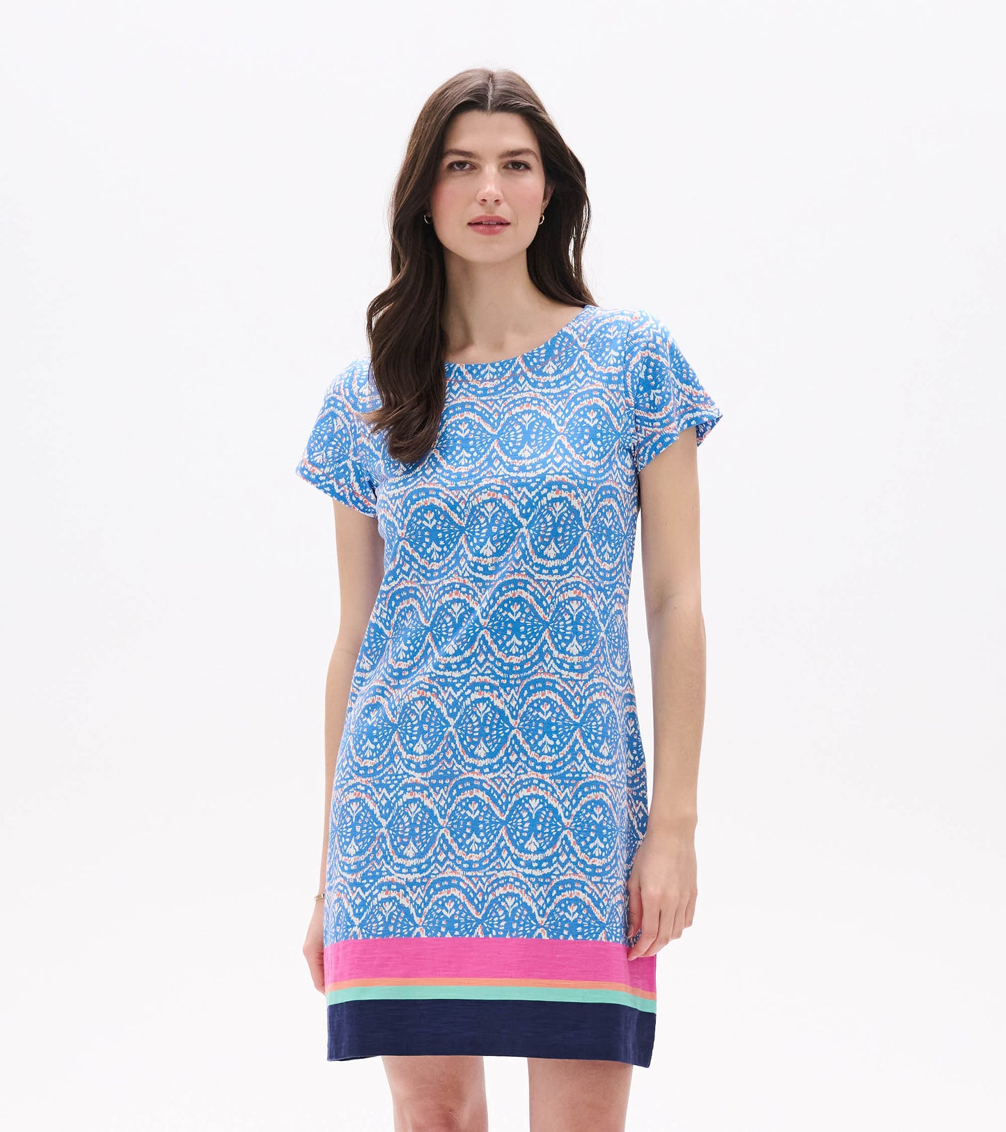 Front view of blue and white ikat tee dress with short sleeves and pink, aqua, and navy border hem