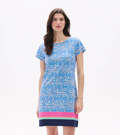 Front view of blue and white ikat tee dress with short sleeves and pink, aqua, and navy border hem