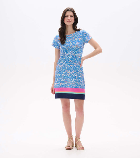 Front view of blue and white ikat tee dress with pink, aqua, and navy striped hem