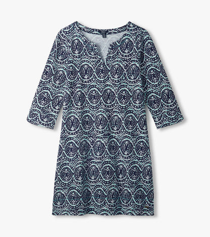 Flat lay of navy Lily notch neck dress with aqua and white ikat print and three-quarter sleeves