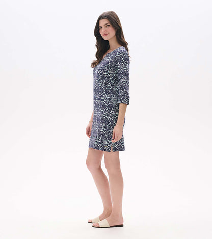 Side view of Lily notch neck dress in navy, aqua, and white ikat print with side hem slit