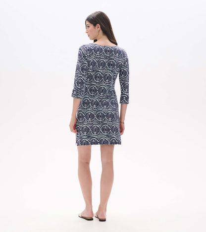 Back view of navy dress with aqua and white ikat print, three-quarter sleeves, and side hem slit
